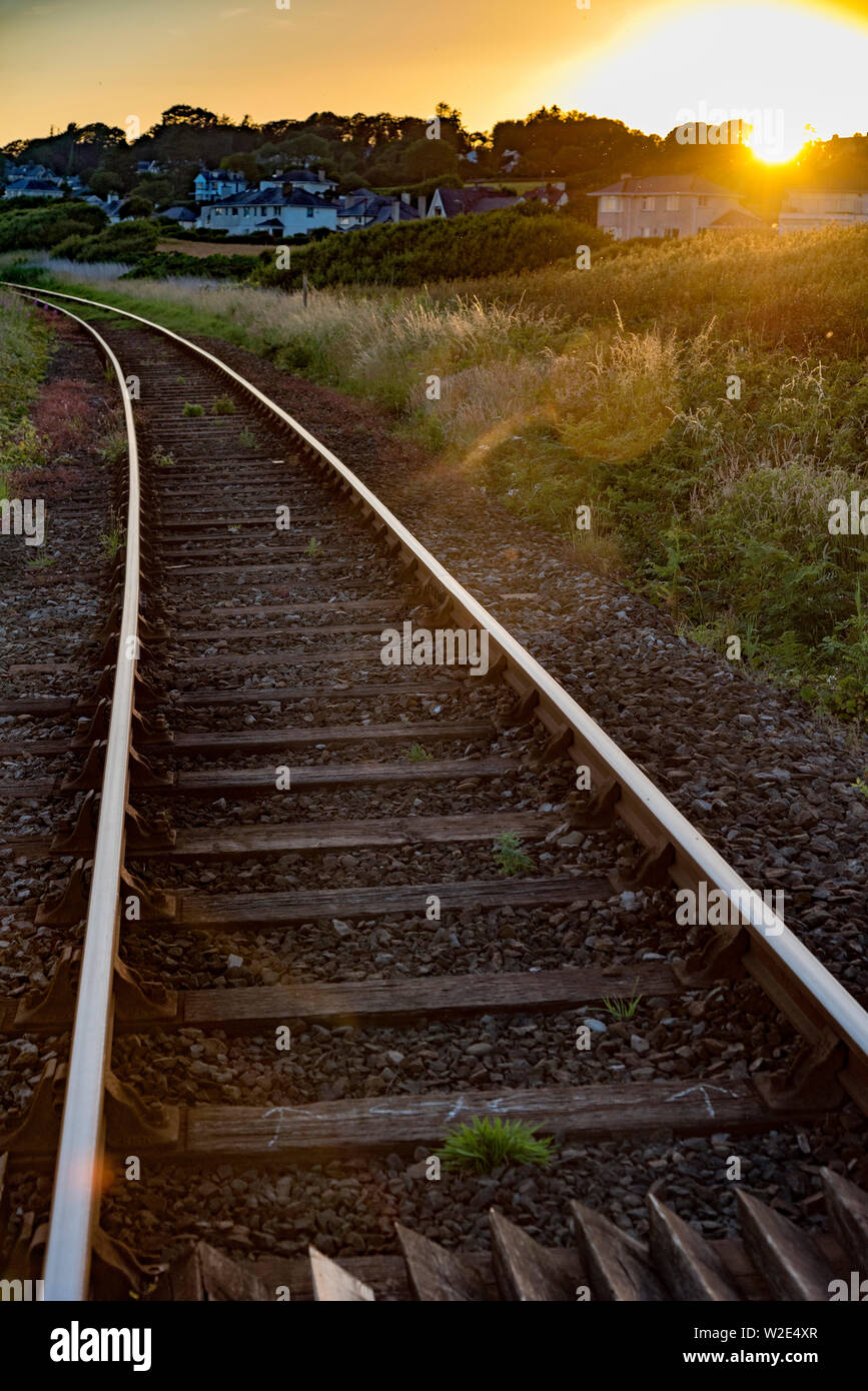 Receding railway lines at sunset. Stock Photo