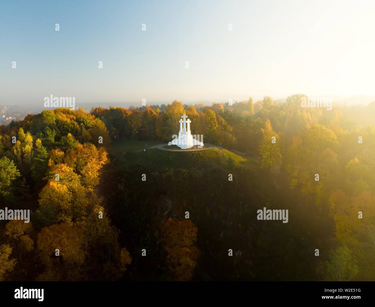 Aerial view of the Three Crosses monument overlooking Vilnius Old Town on sunset. Vilnius landscape from the Hill of Three Crosses, located in Kalnai Stock Photo