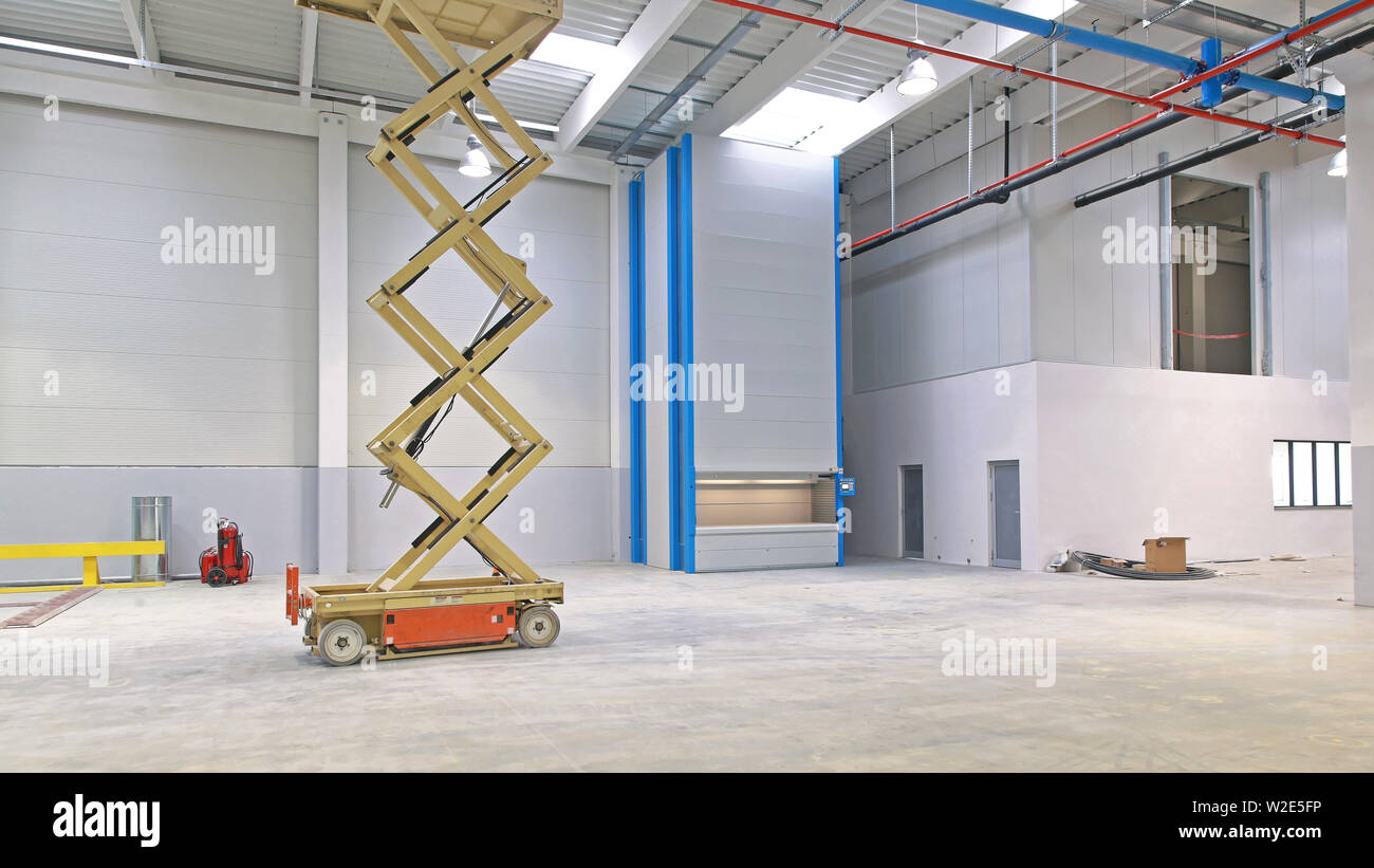 New Factory Hall With Hydraulic Scissors Lift Platform Stock Photo