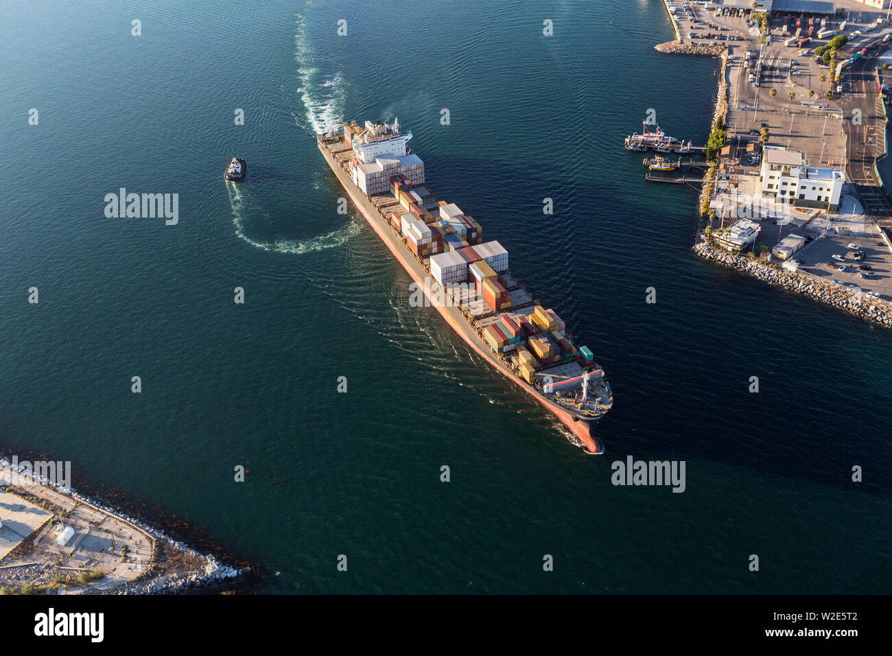 Container cargo ship leaving Long Beach harbor and heading out to the Pacific Ocean. Stock Photo