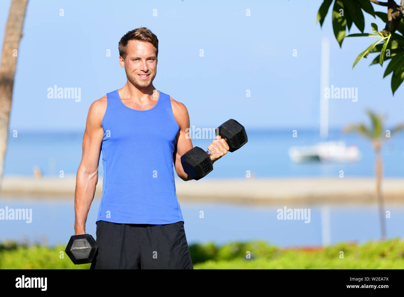 Fitness bicep curl weight training man outdoors working out arms