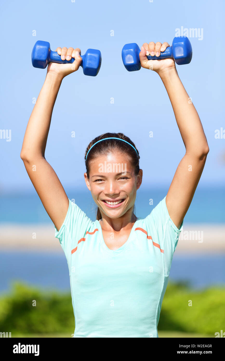 Beautiful fit woman fitness exercises outdoors. Stock Photo by