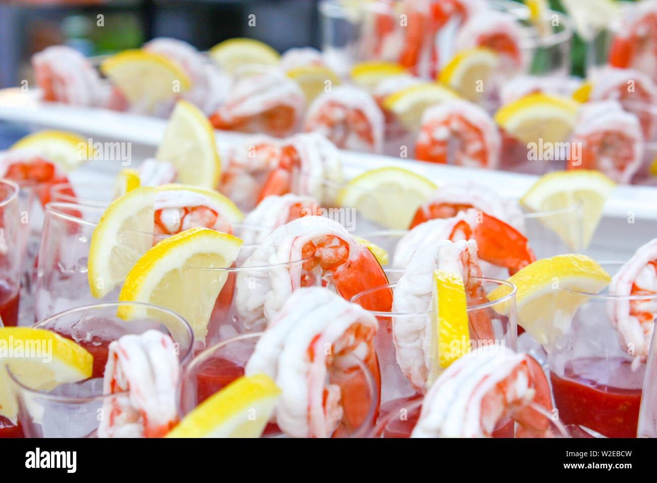 Boiled shrimp with lemon beside before appetizer. Stock Photo