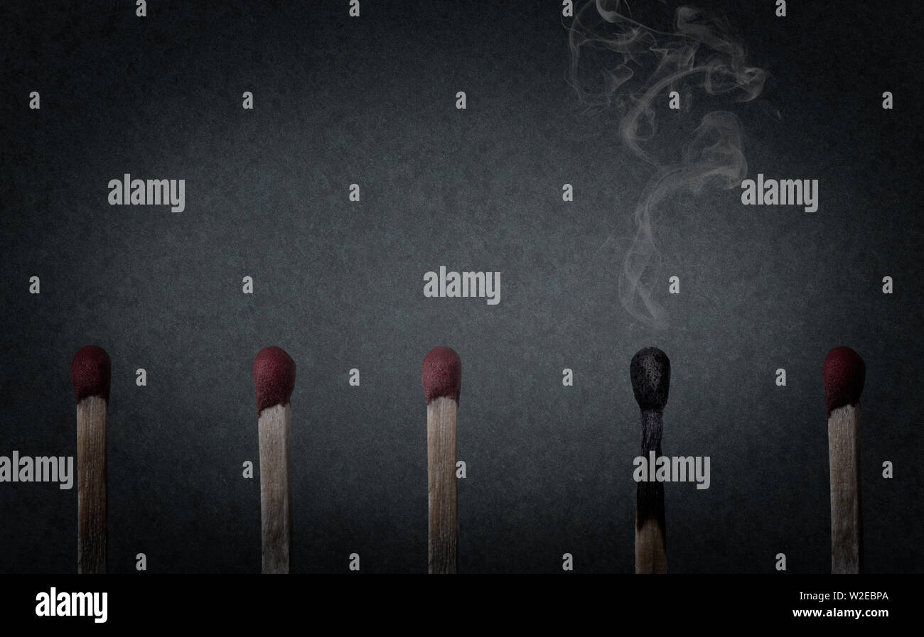 burnout concept, burnt match with smoke on blue background, work and life Stock Photo