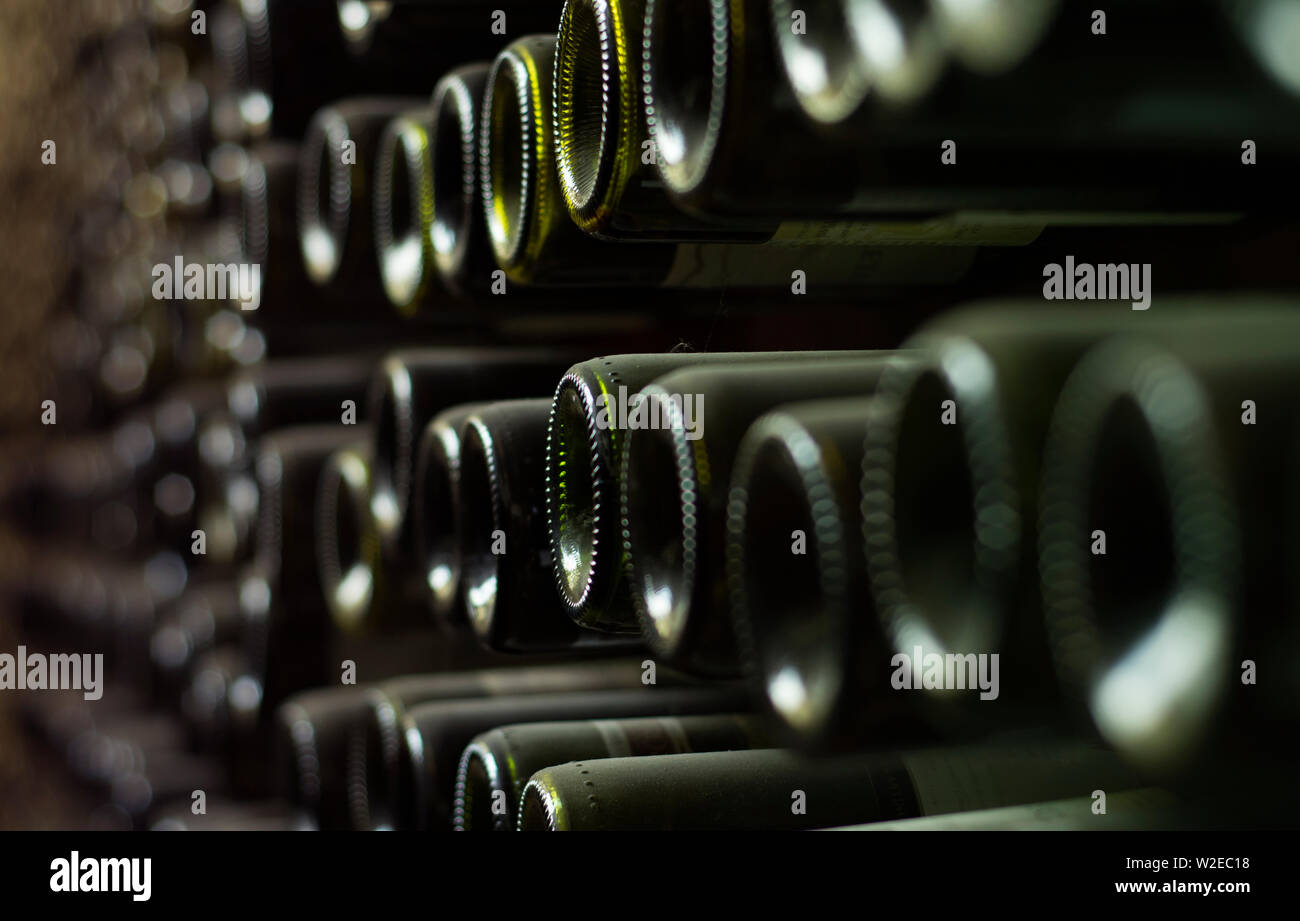 wine cellar wall with soft light on wine bottles Stock Photo