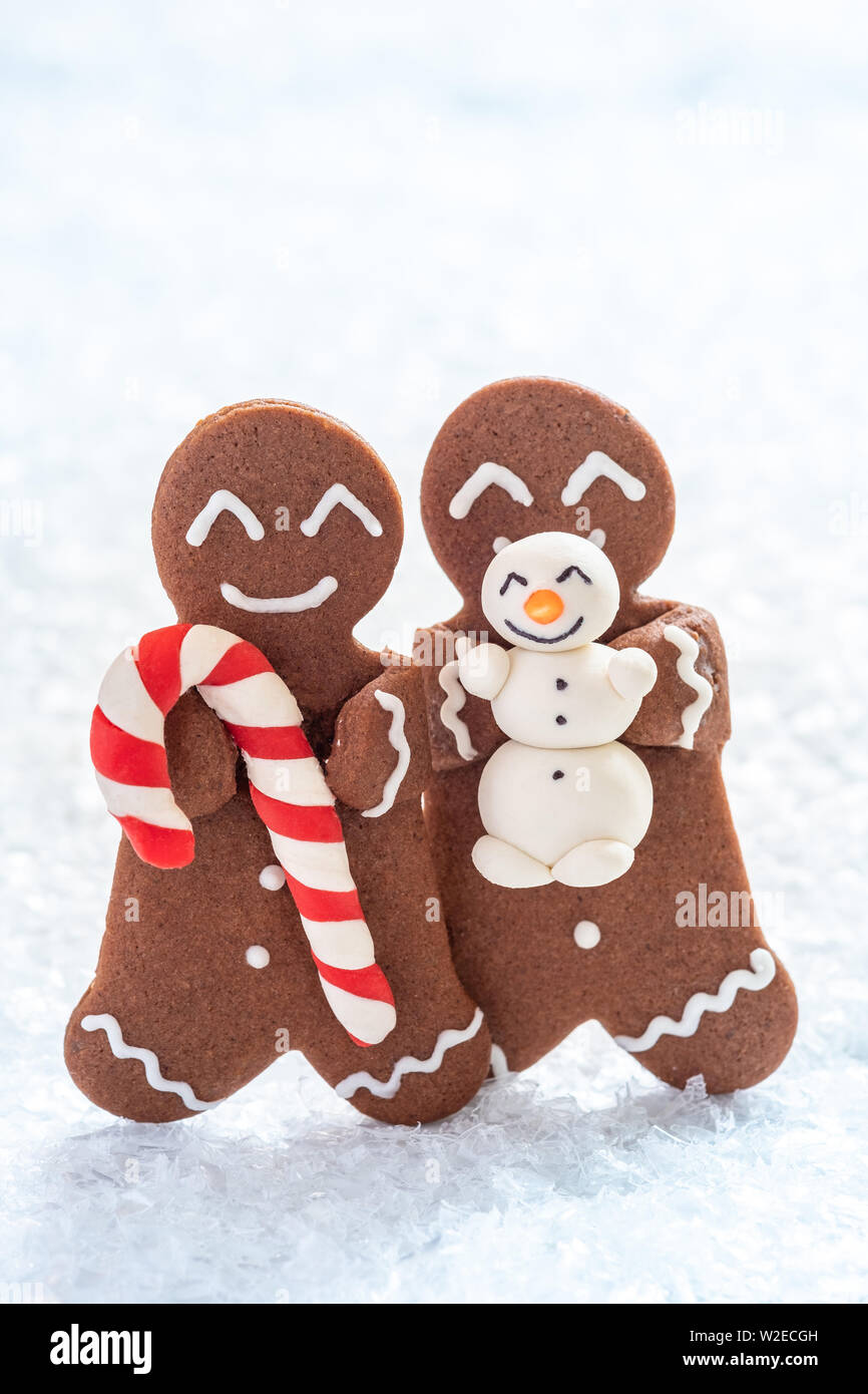 Gingerbread cookie men with tiny marzipan snowman Stock Photo