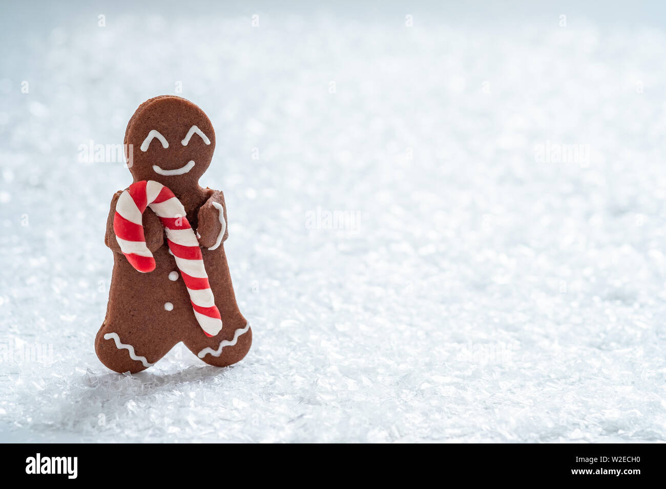 Gingerbread cookie men with tiny marzipan snowman Stock Photo