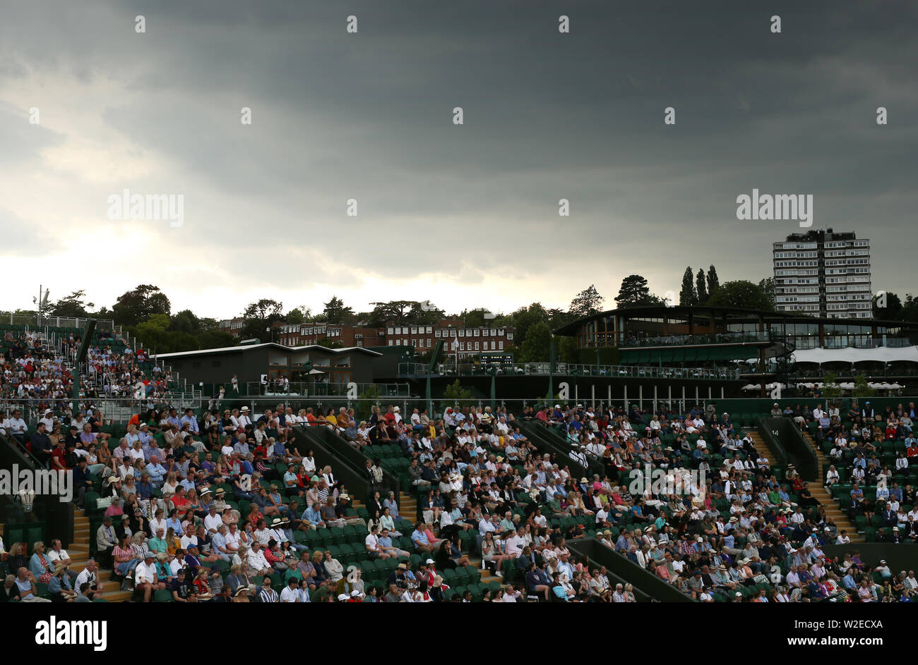 Grey clouds gather over court 2 on day seven of the Wimbledon Championships at the All England Lawn Tennis and Croquet Club, London. Stock Photo