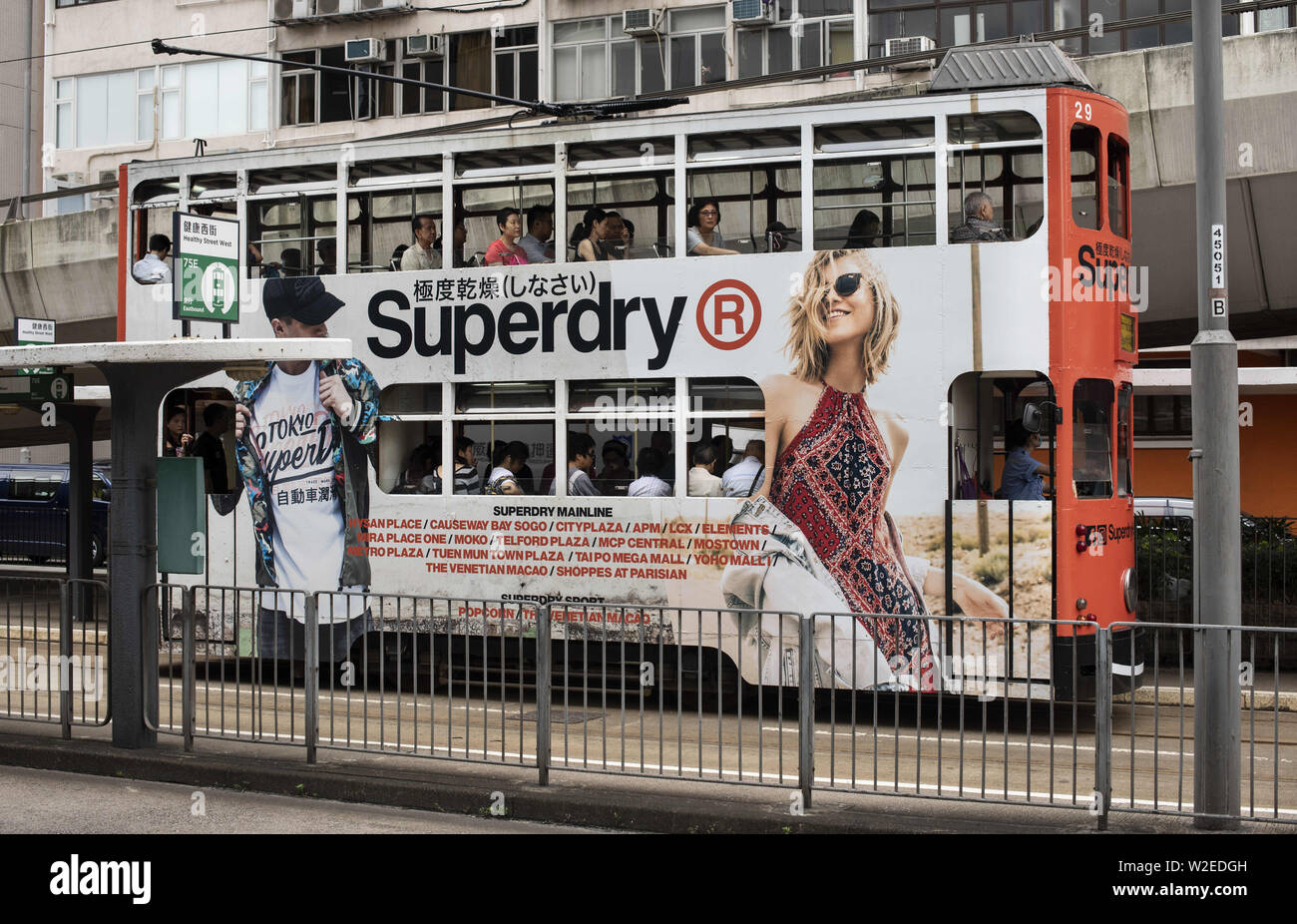 Hong Kong, China. 25th June, 2019. Double-deck tram runs in Hong Kong  covered with British clothing brand Superdry brand advertisement theme.  Credit: Budrul Chukrut/SOPA Images/ZUMA Wire/Alamy Live News Stock Photo -  Alamy
