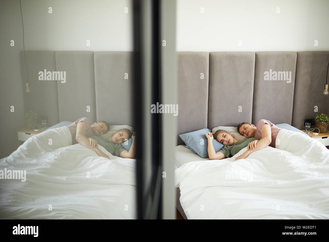 Young Affectionate Sleeping Couple Lying In Bed Under Blanket By