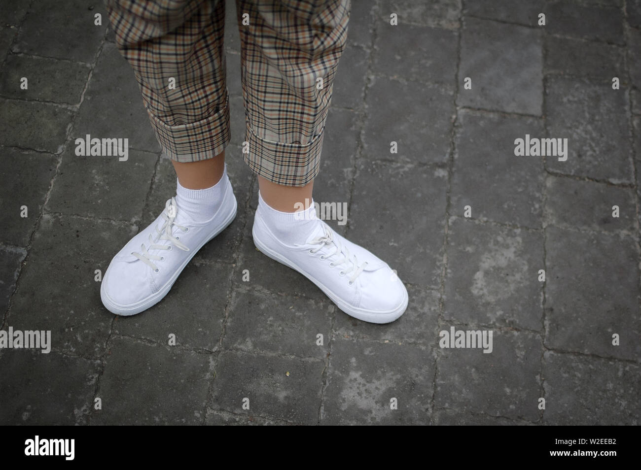 White sneaker shoes standing on the street. Hipster or casual concept Stock  Photo - Alamy