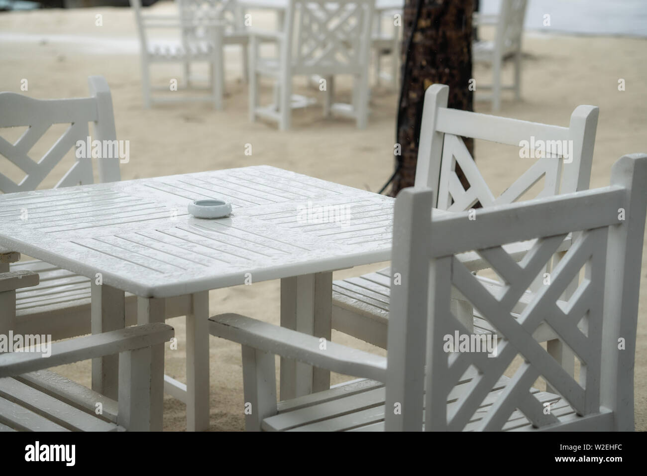 White table restaurant on the beach. The rainy season has begun Stock