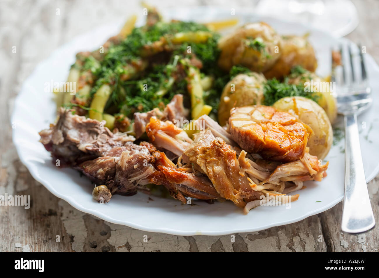 Roast pork with green beans & baby potatoes Stock Photo Alamy