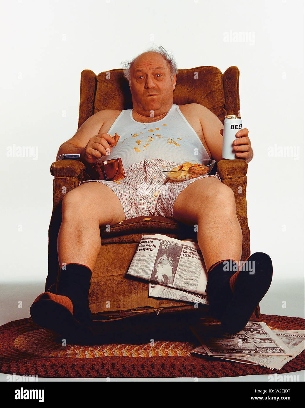 Senior male sitting on a recliner in his undershirt in boxers looking like  a slob Stock Photo - Alamy