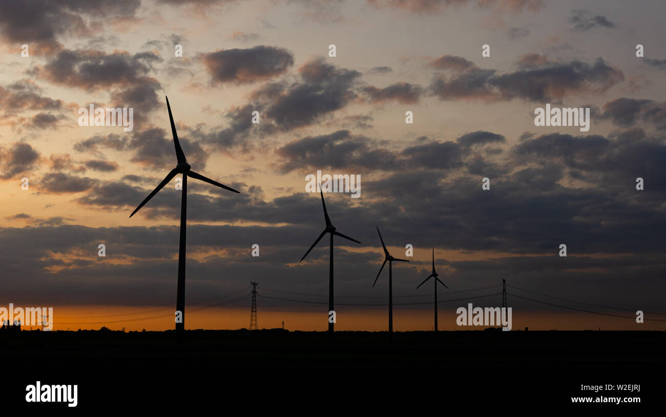 sunset with wind turbines, concept of renewable, ecological energy Stock Photo