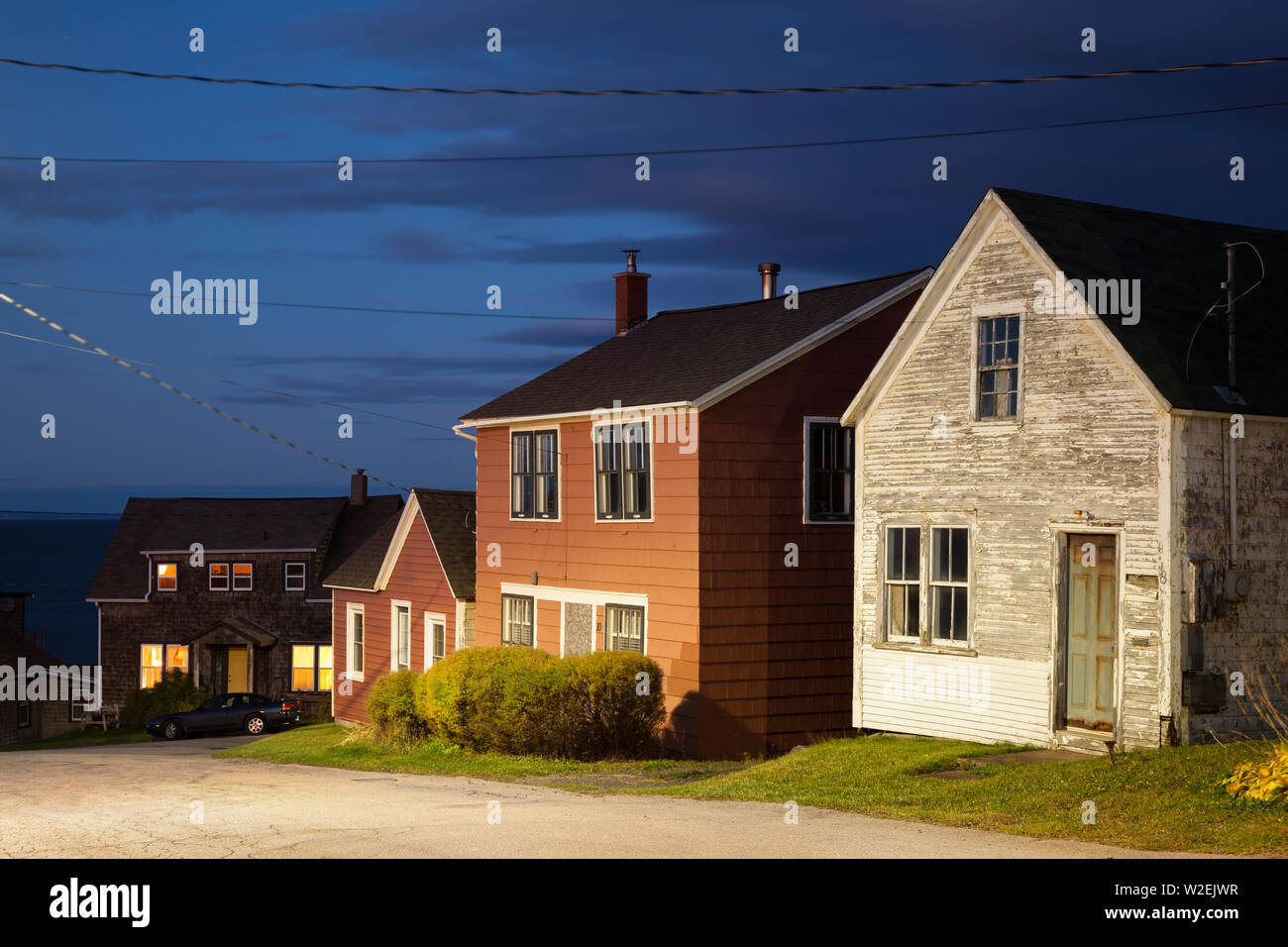 Typical wooden houses that are found in the Maritimes at dusk in the town of Margarettesville, Annapolis County, Nova Scotia, Canada. Stock Photo