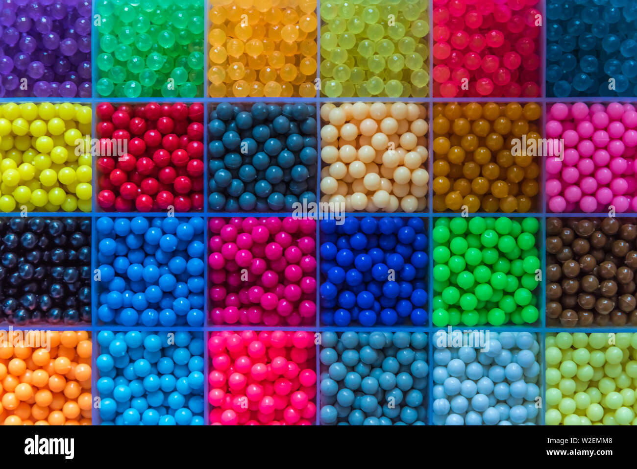 Many small beads are arranged in the box Stock Photo