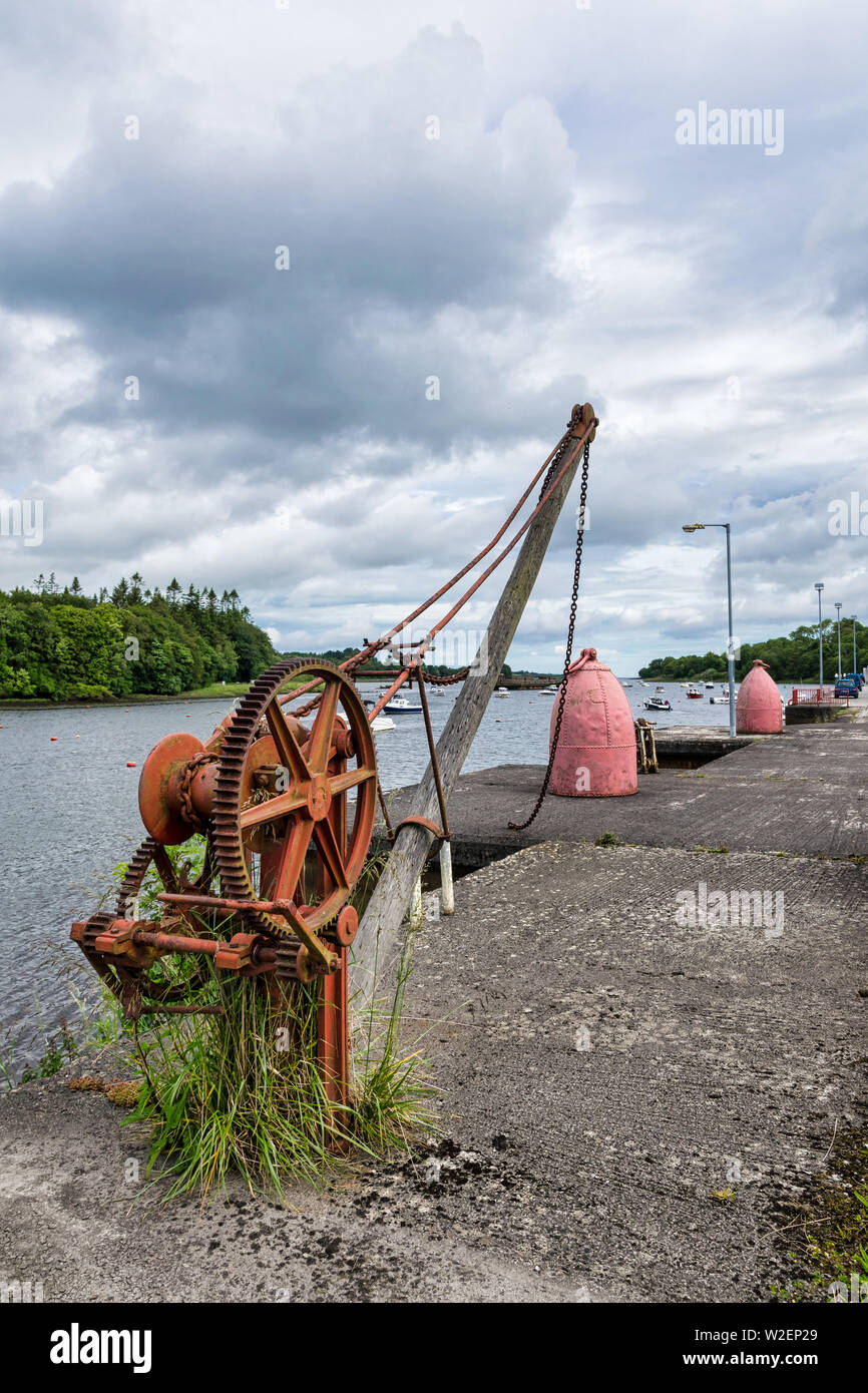 This is an old rusting metal crane that was once used for lifting material out of boats Stock Photo