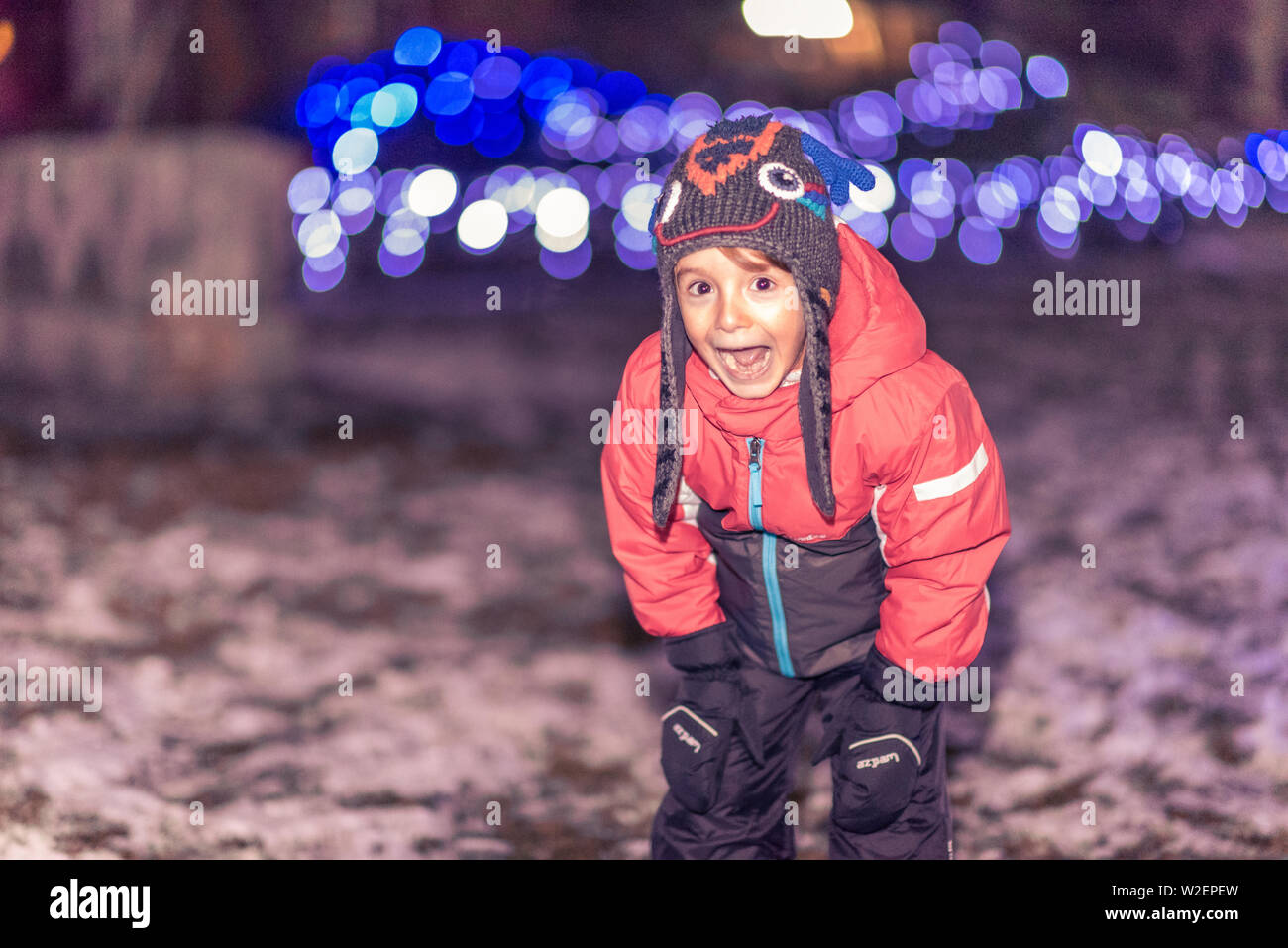 In the mood for fun, for playing with snowballs, for spending time outdoors, playing. He is the little boy with blinking eyes when it comes to play an Stock Photo