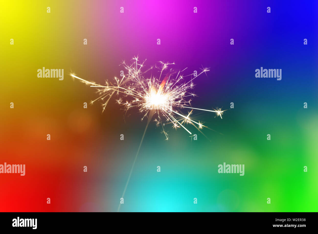 Sparks from hand cold fireworks colorful background Stock Photo