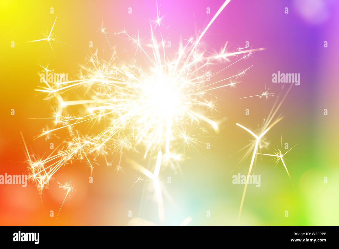 Sparks from hand cold fireworks bright sunspot colorful background Stock Photo