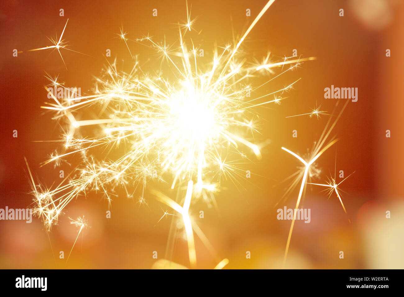 Sparks from hand cold fireworks bright sunspot background Stock Photo
