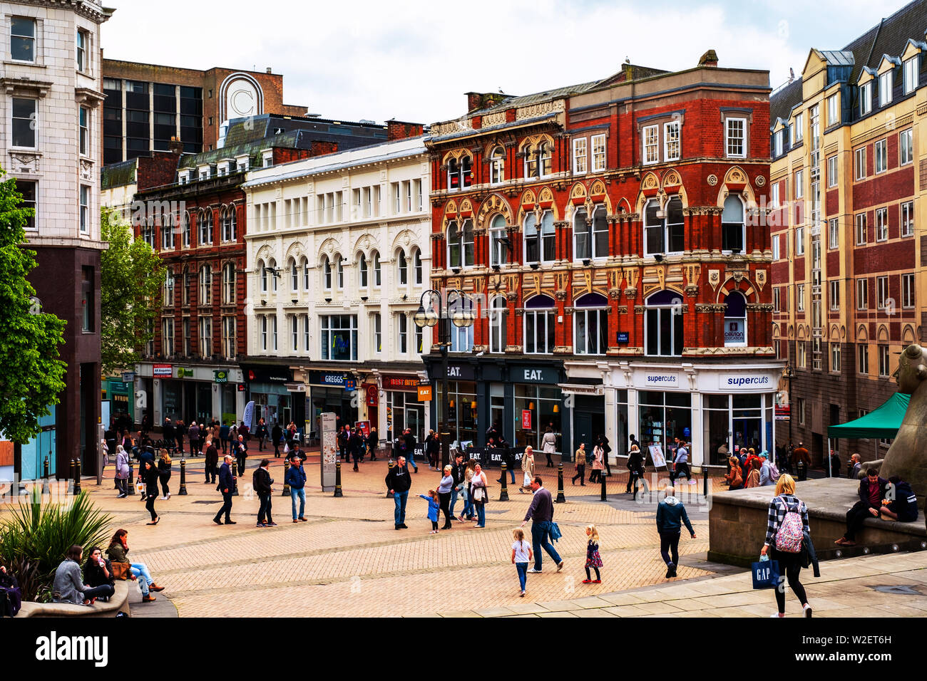 BIRMINGHAM, UK - MAY 19, 2017: Busy street in the city center of Birmingham, UK. Crowded streets with various shops and restaurants during the day Stock Photo