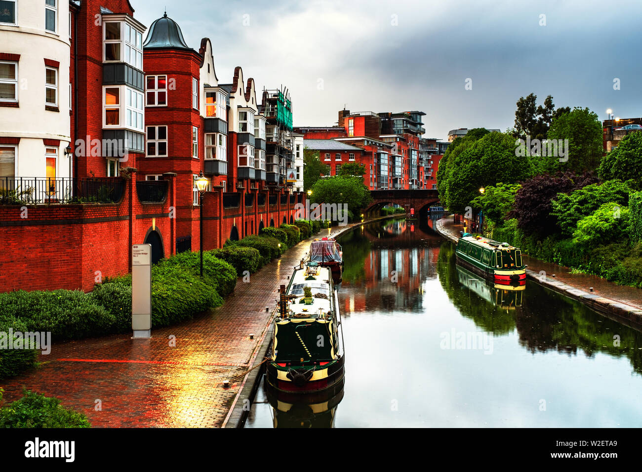 Birmingham, UK. Embankments during the rain in the evening at famous Birmingham canal in UK. Cloudy blue sky at night Stock Photo