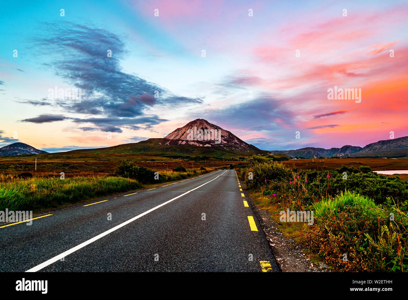 Donegal, Ireland. Mountain Errigal in Donegal county, Ireland in the evening at sunset with highway and colorful sky Stock Photo
