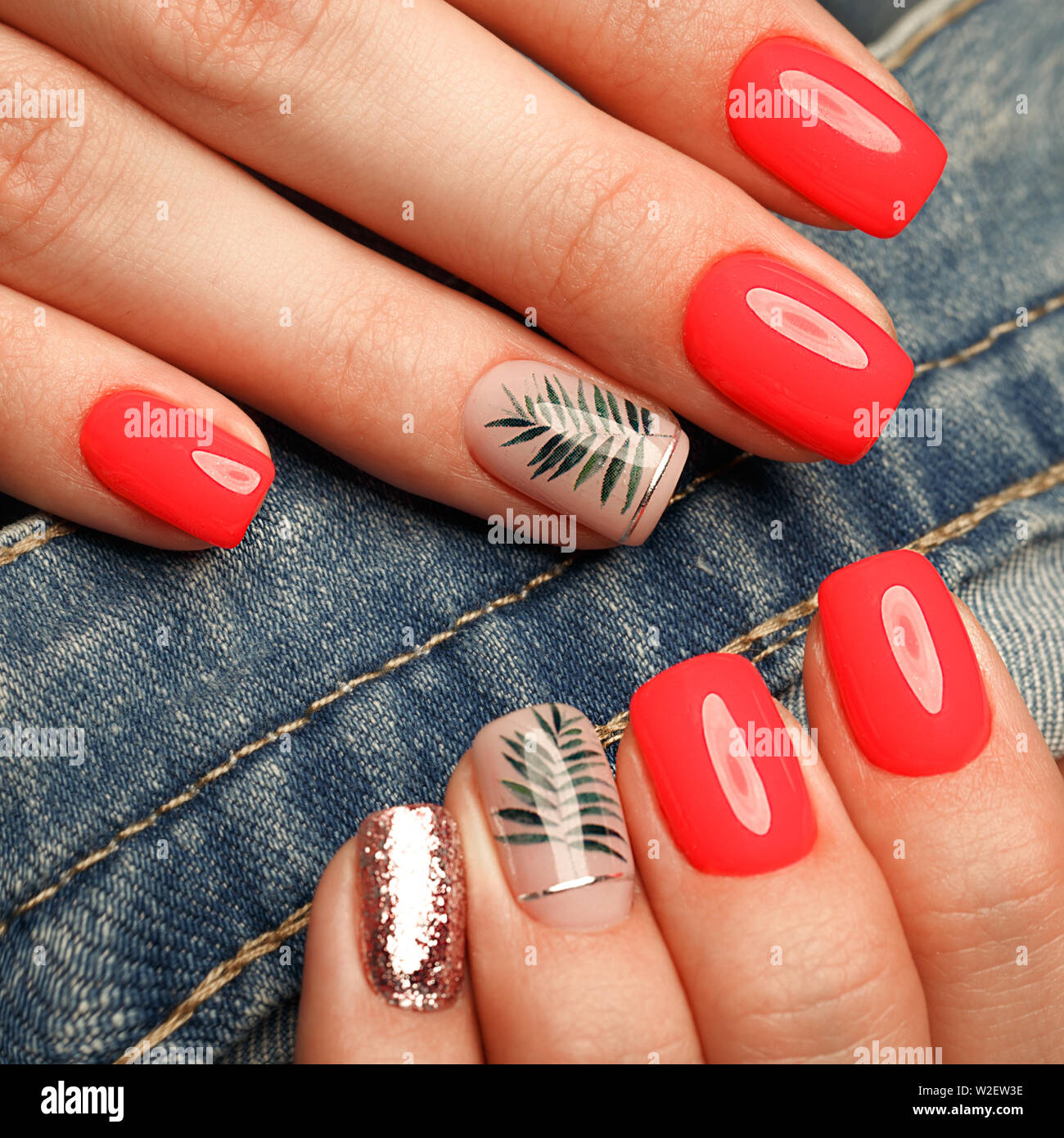 Bright neon manicure on female hands on the background of jeans. Nail design.  Beauty hands Stock Photo - Alamy