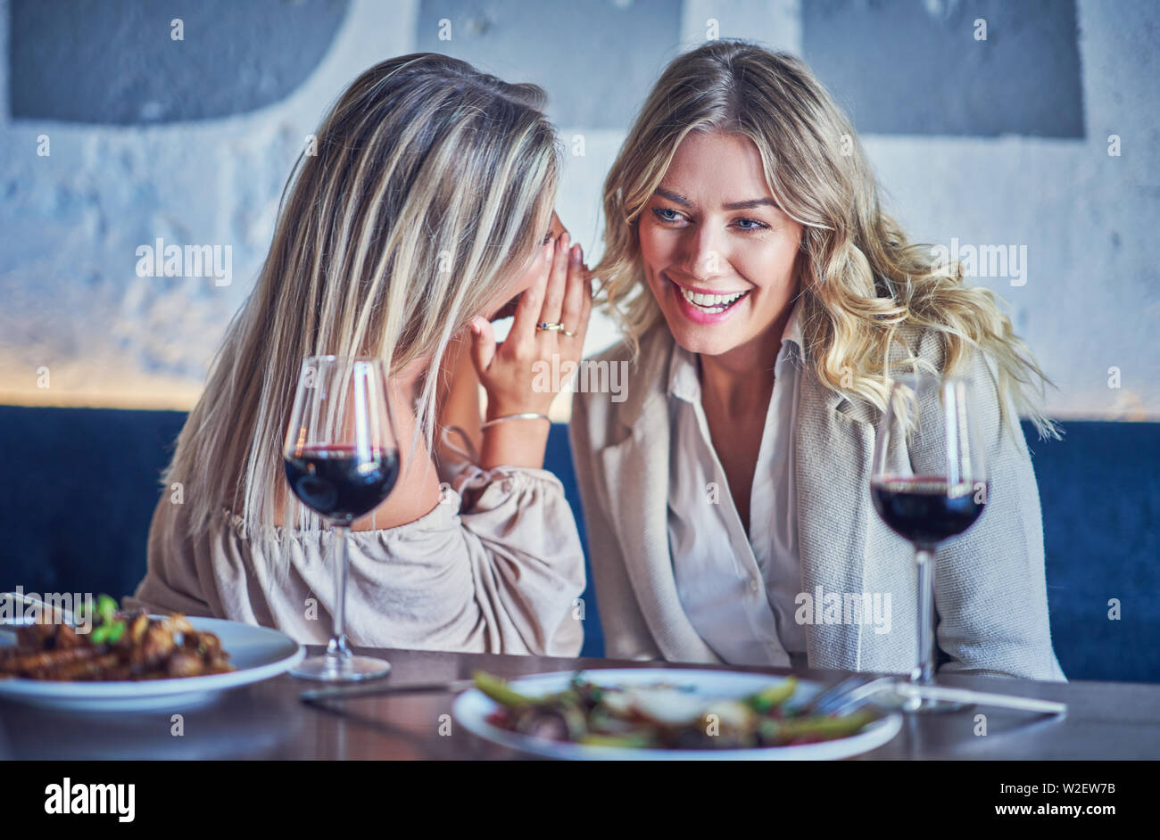 Two girl friends eating lunch in restaurant Stock Photo