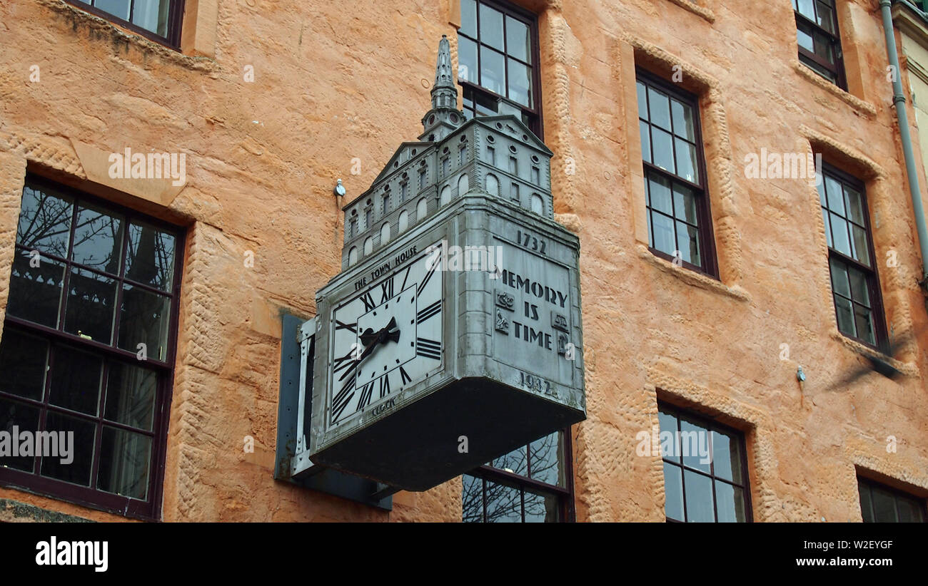 Public clock with rectangular face and Roman numerals mounted on the ...