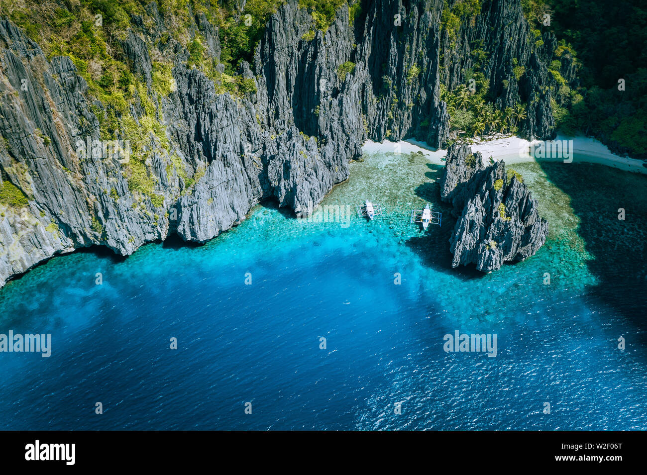 El Nido, Palawan, Philippines. Aerial above view of banca boats surrounded  by karst scenery rocks at Secret Lagoon beach Stock Photo - Alamy
