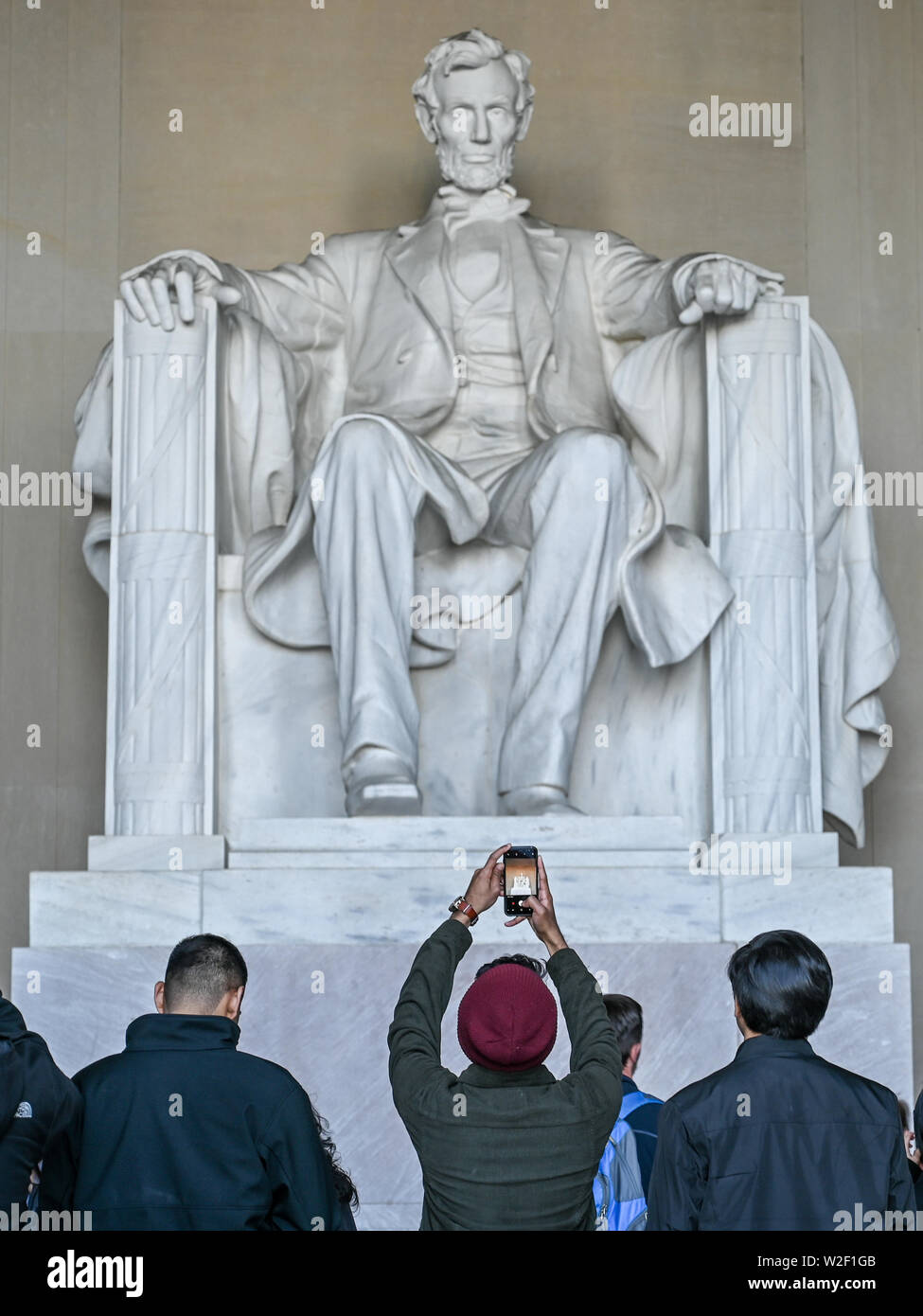 Tourists take snapshots of Abraham Lincoln inside Lincoln Memorial during spring 2019 in Washington DC Stock Photo