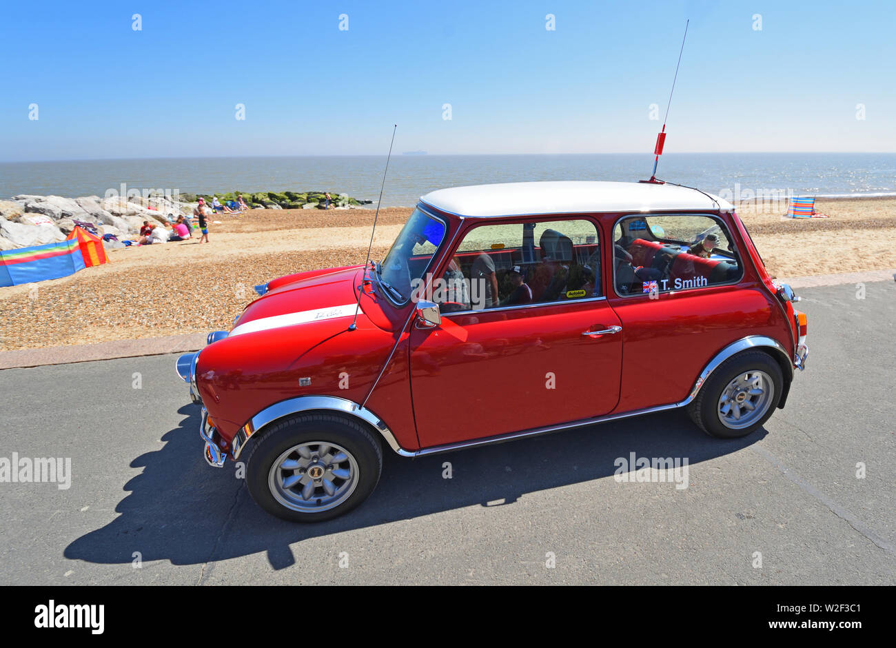 Classic Red Austin Mini Car parked on seafront promenade. Stock Photo