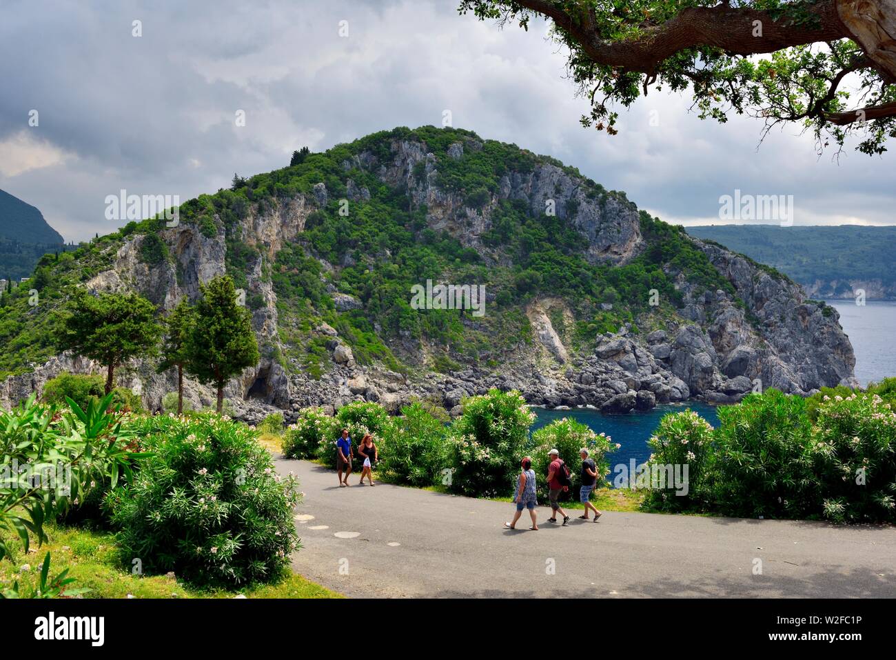 Tourists walking down from Paleokastritsa monastry,Theotokos Monastery, Corfu, Greece Stock Photo