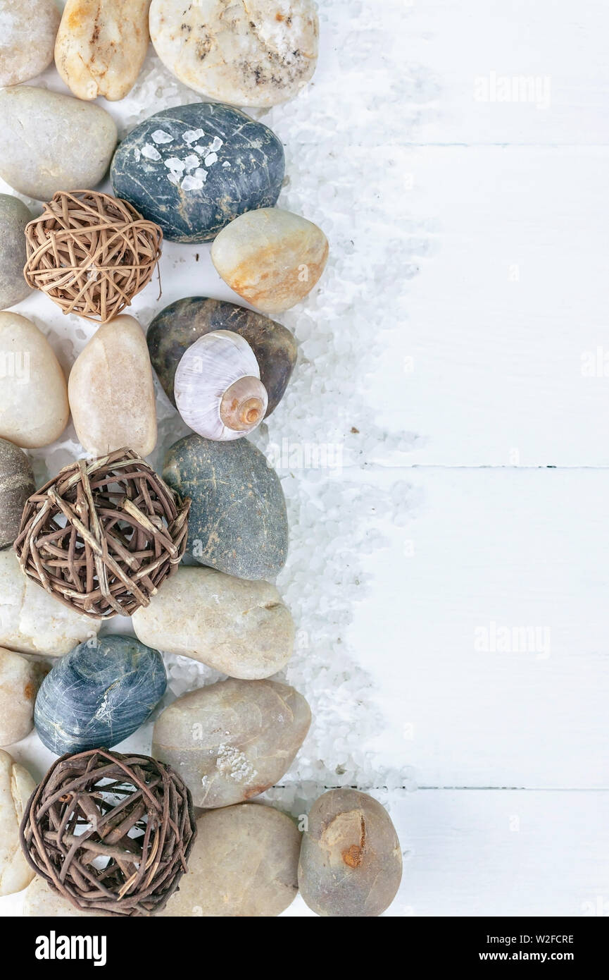 Vertical SPA flat lay. Sea pebbles, sea salt on a light wooden background. Top view Stock Photo
