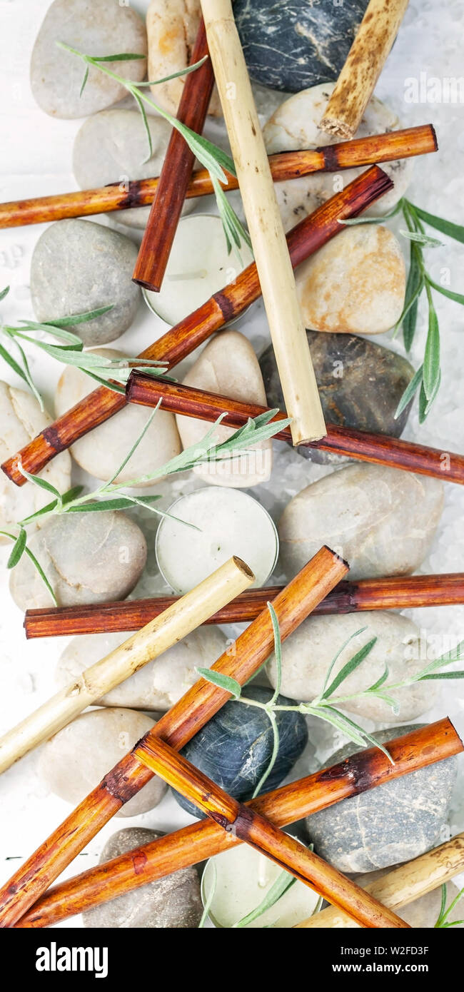 Vertical SPA banner. Bamboo, sea pebbles, scented candles, sea salt on a light wooden background Stock Photo