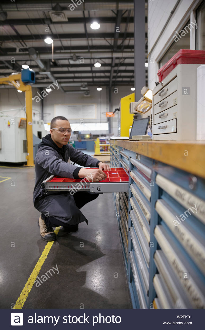 Male machinist at tool box in factory Stock Photo Alamy