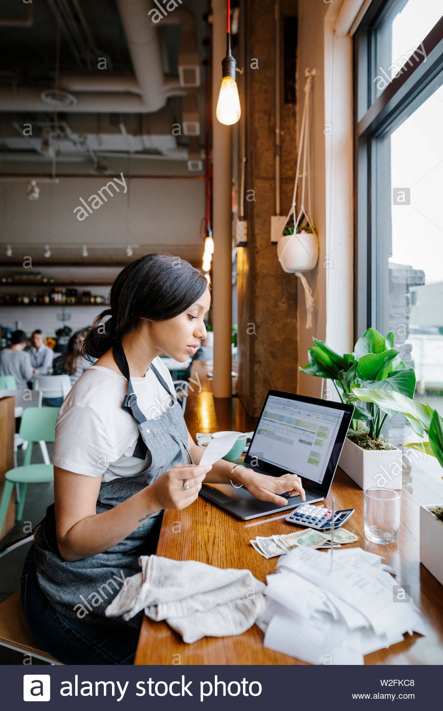 Restaurant owner calculating receipts Stock Photo