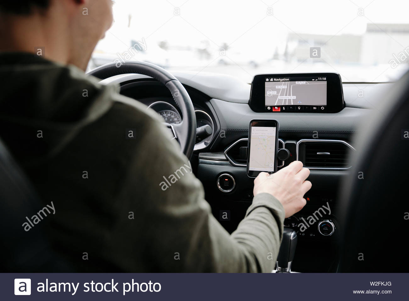 Man using smart phone GPS while driving car Stock Photo Alamy