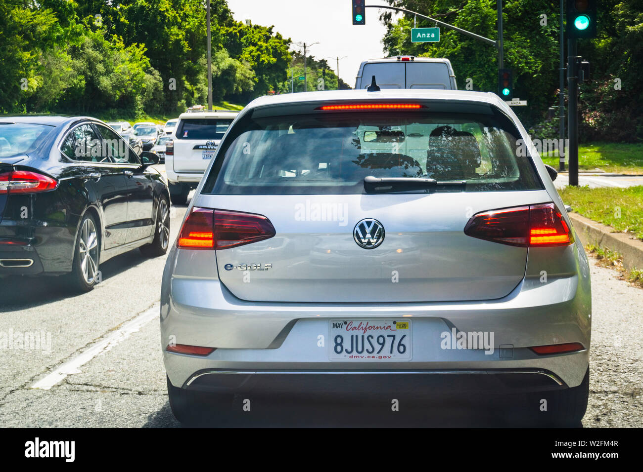July 4, 2019 San Francisco / CA / USA - Back view of Volkswagen e-Golf driving on a busy the city street; VW e-Golf is the electric version of the reg Stock Photo
