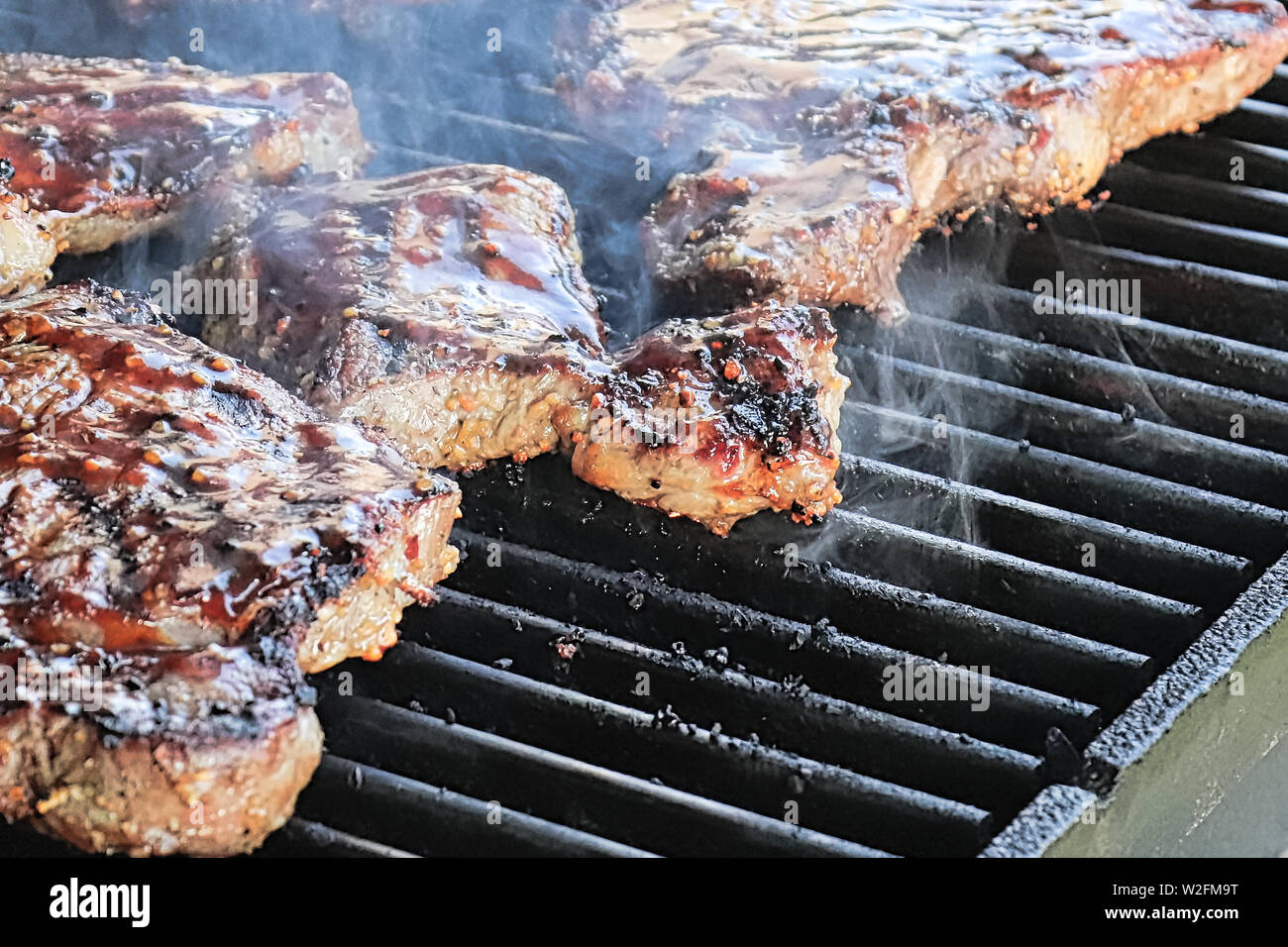 Closeup of steaks cooking on a BBQ Stock Photo Alamy