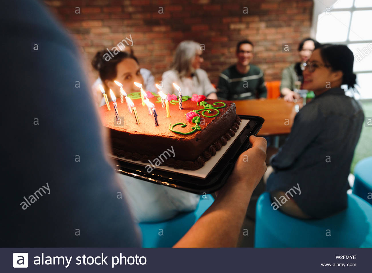 Businessman carrying birthday cake in office Stock Photo Alamy