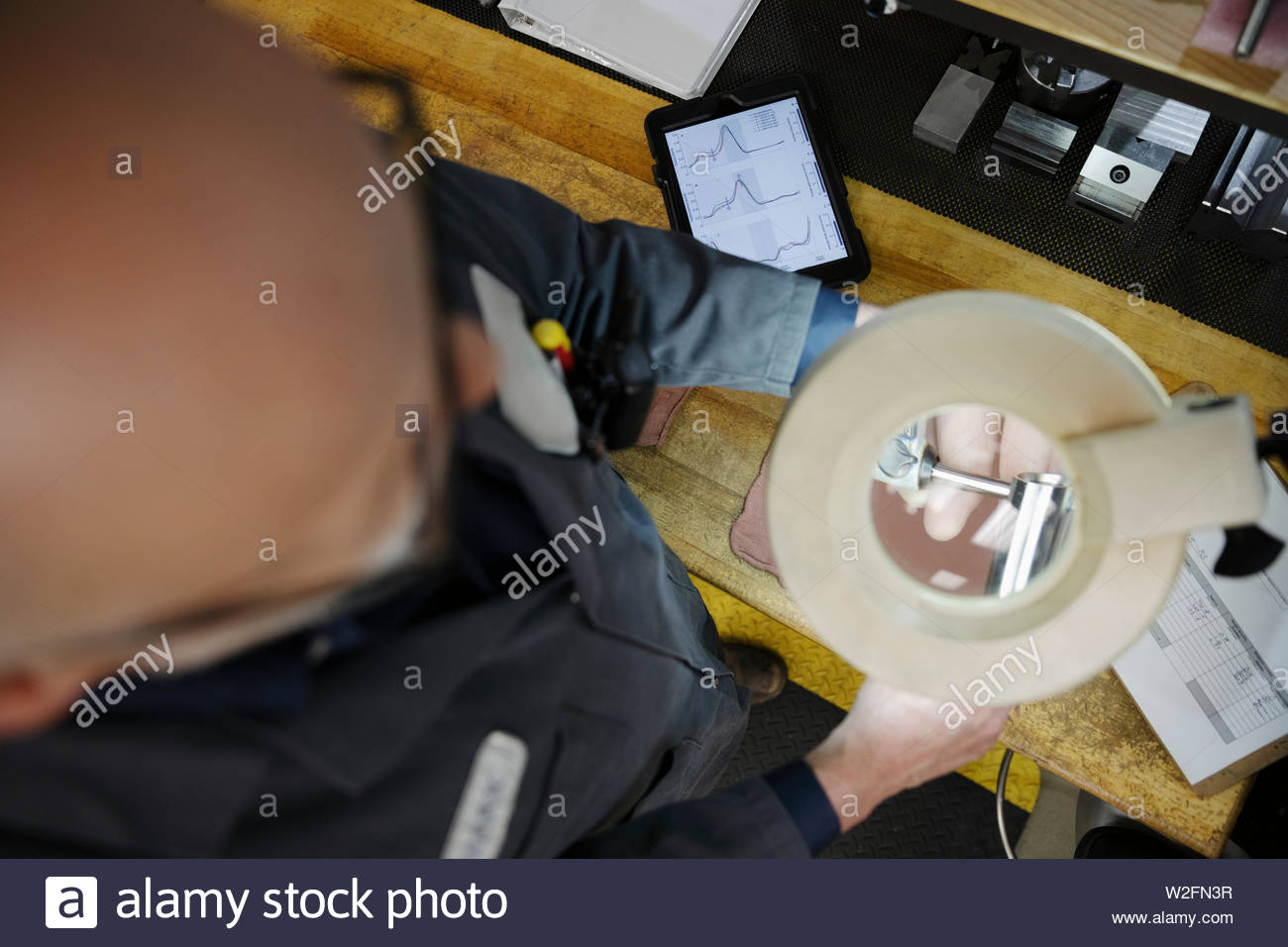 Machinist using magnifying lamp Stock Photo Alamy