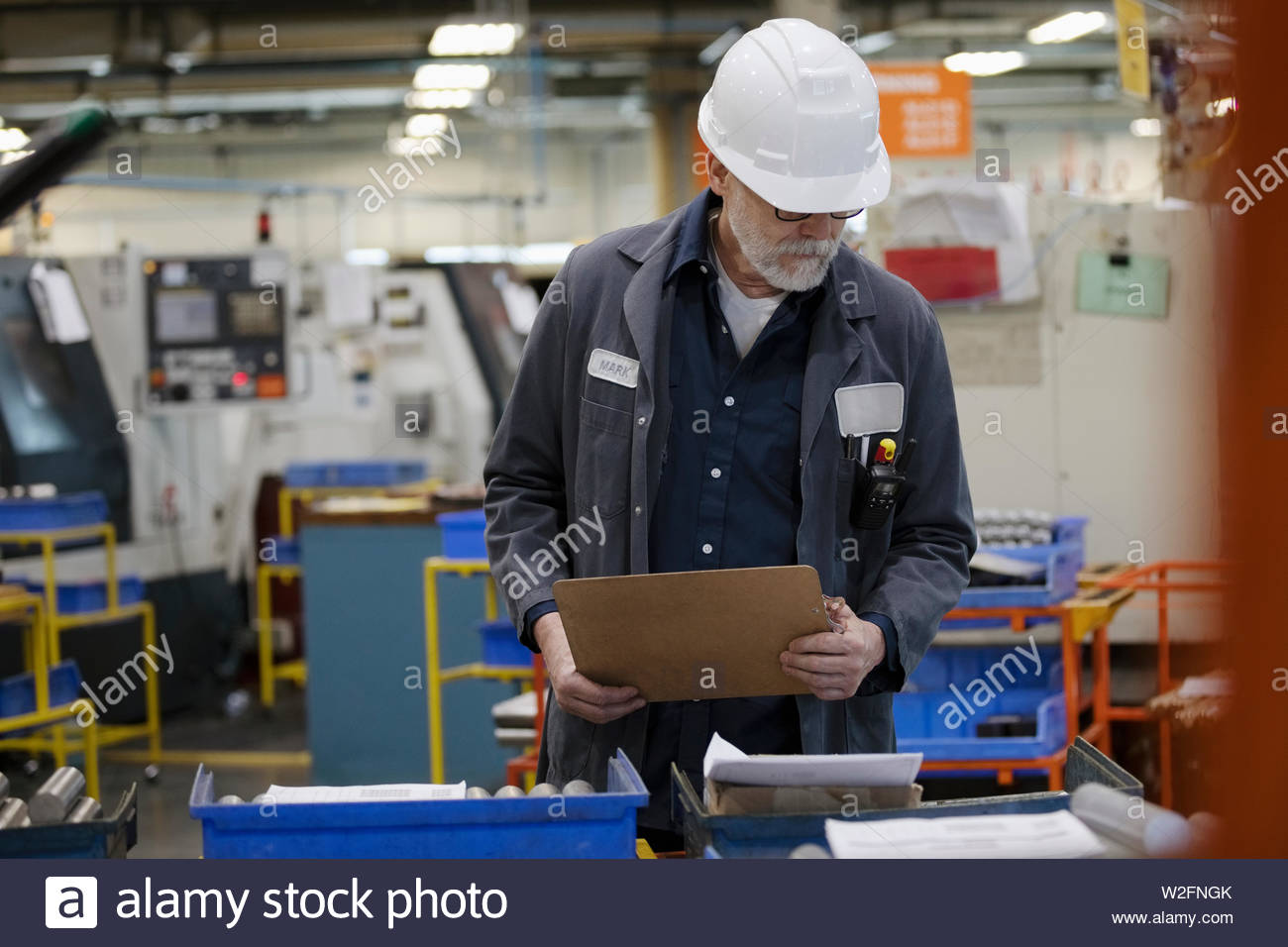 Machine shop supervisor inspecting equipment Stock Photo