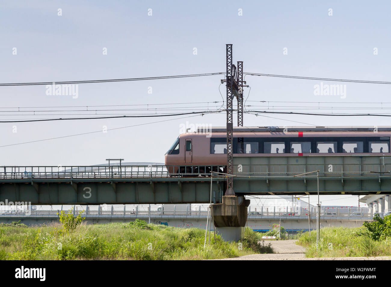 An Odakyu 30000 series EXE Excellent Express train on a rail bridge in ...