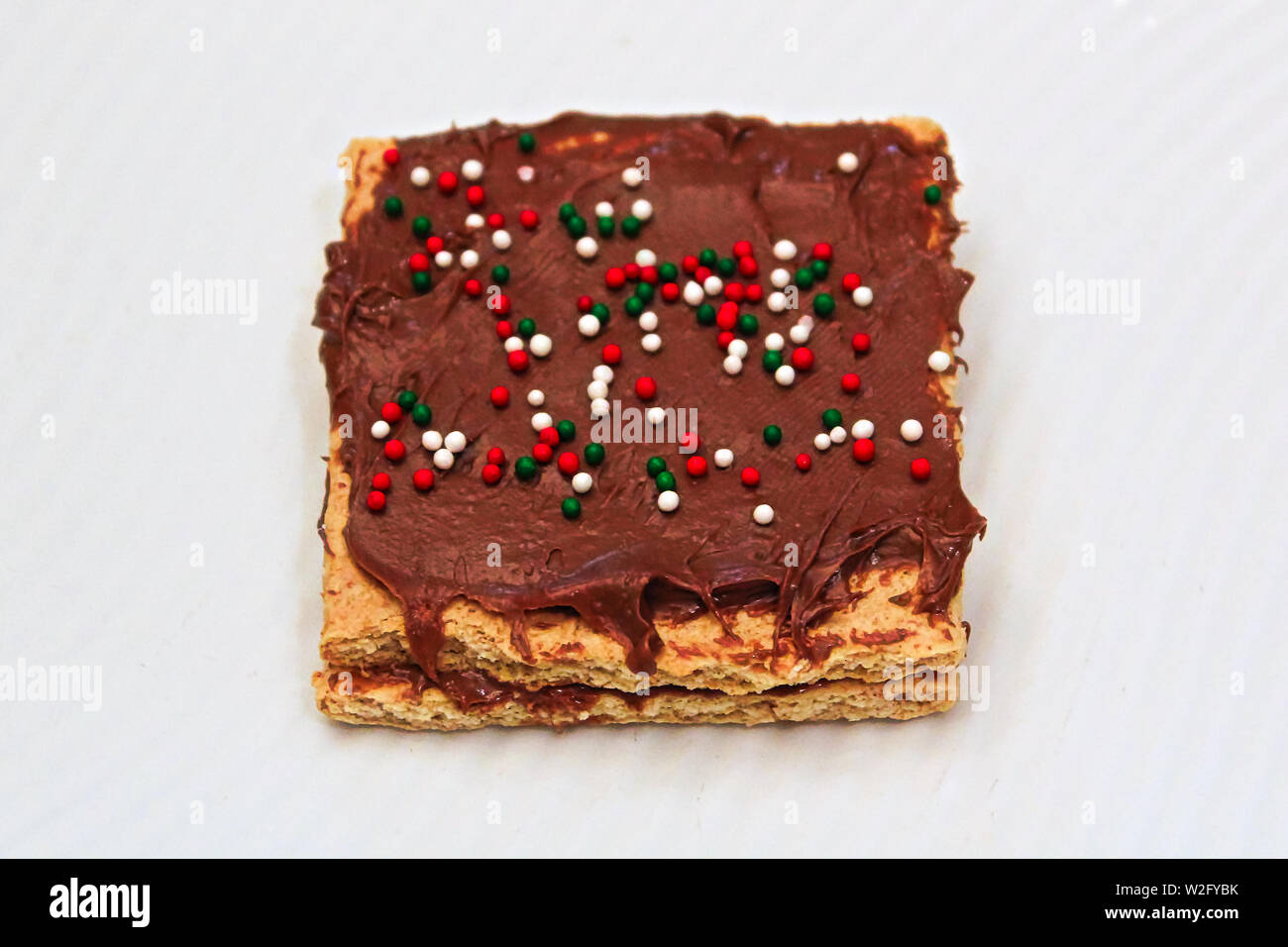 Closeup of grapham crackers spread with chocolate and sprinkles Stock