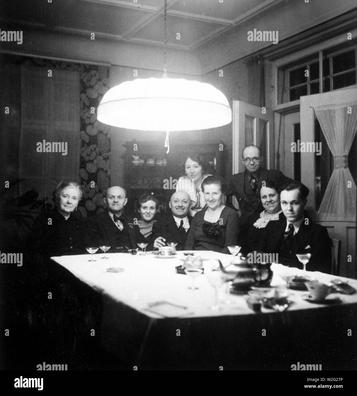 Eva Braun Collection (Album 2) - Family sitting for group portrait at table in what appears to be a dining room Stock Photo