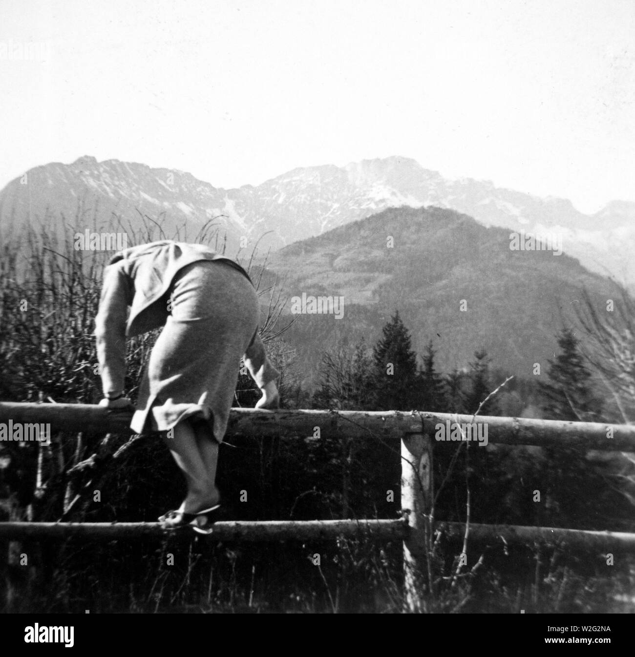 Eva Braun Collection (album 3)  - Woman climbing a fence in 1930s or 1940s Germany Stock Photo